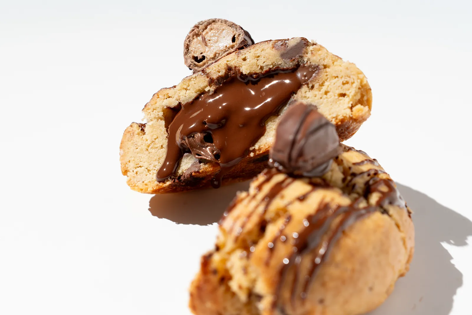 A cookie with chocolate pieces on a white background.