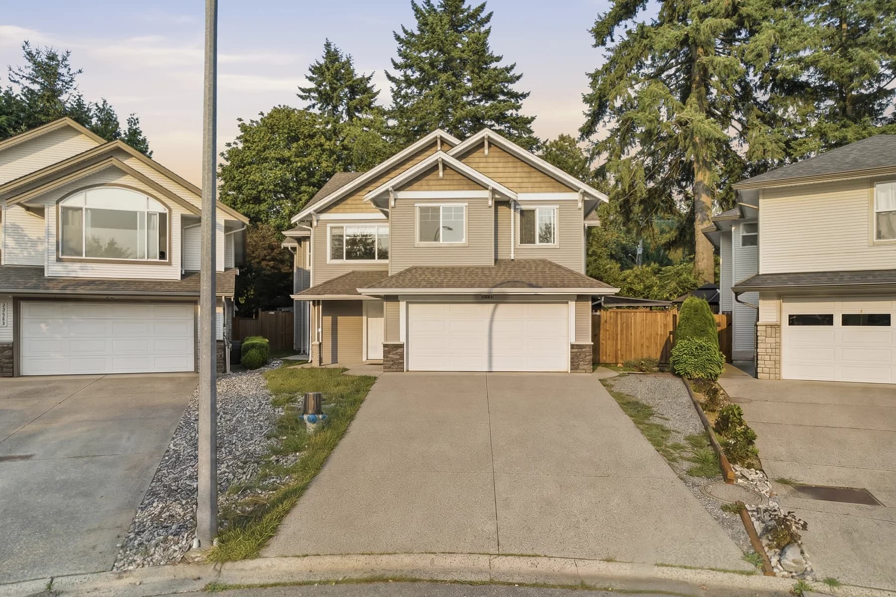 Front elevation with the driveway approach, a kitchen and dining room in one frame, the fireplace living room, and the rear deck over a full garden.