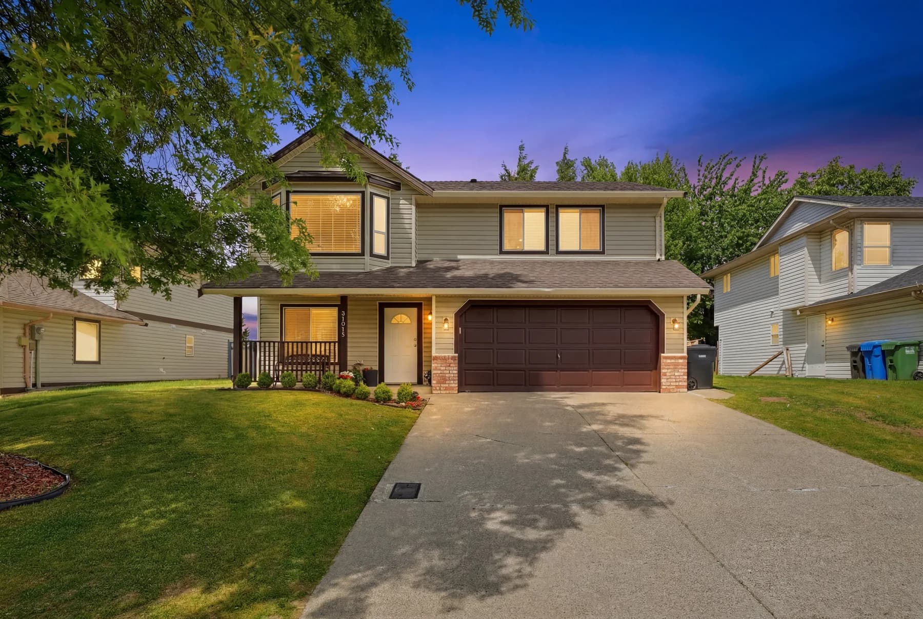 Twilight frontage against a blue-to-violet sky, then the rooms the house is sold on: a grey gloss kitchen, the main living space, the dining room and the primary bedroom.